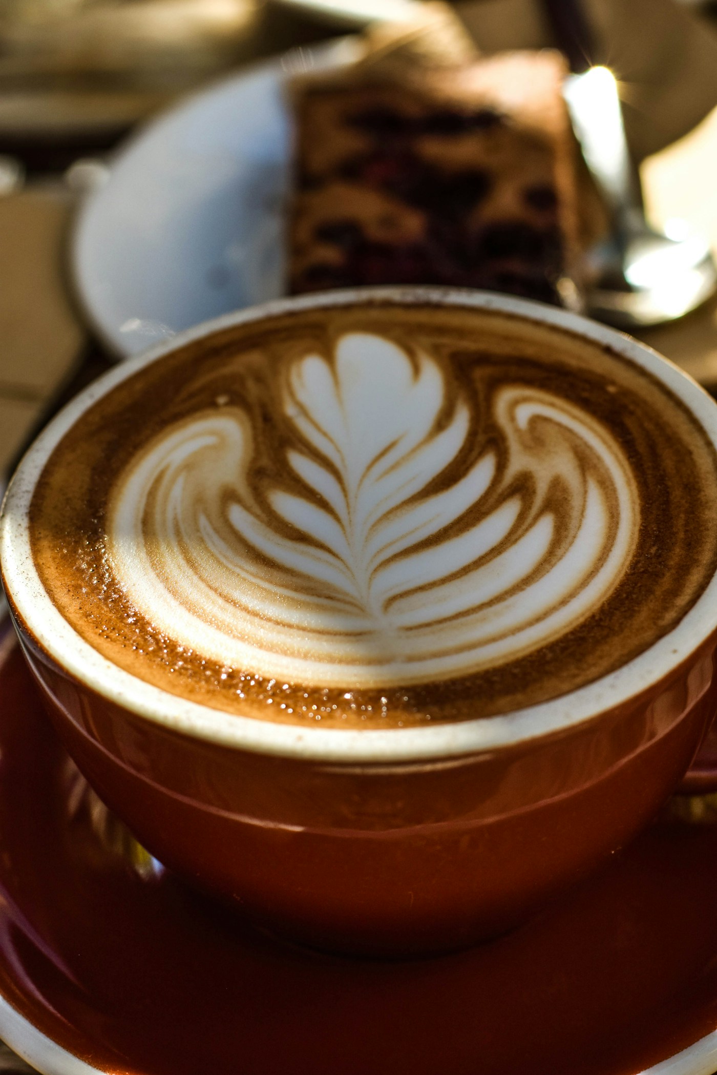 A warm latte with leaf-shaped foam art